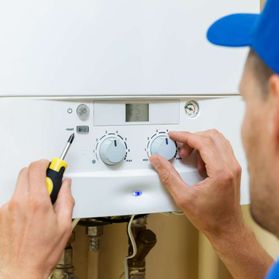 A plumber working on a boiler